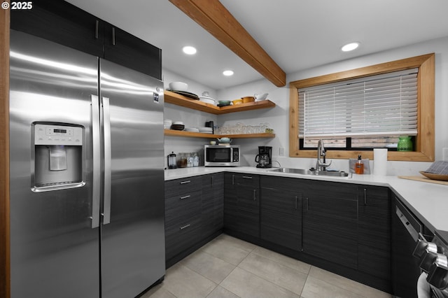 kitchen with light tile patterned flooring, a sink, light countertops, appliances with stainless steel finishes, and dark cabinets