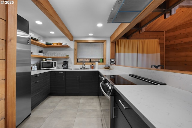 kitchen featuring a sink, appliances with stainless steel finishes, dark cabinets, and light tile patterned floors