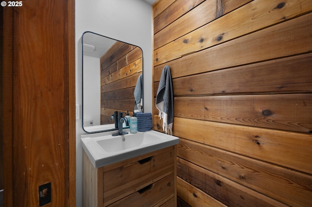 bathroom with wooden walls and vanity