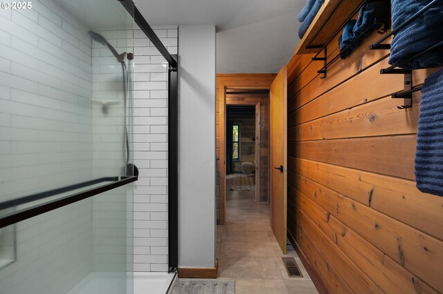 full bath featuring visible vents, a stall shower, and wood walls