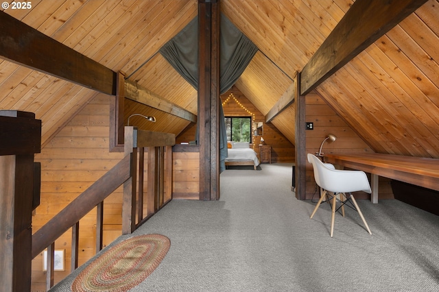 home office featuring lofted ceiling with beams, wooden walls, wooden ceiling, and carpet