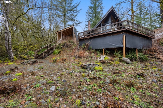 back of property with stairs and a deck