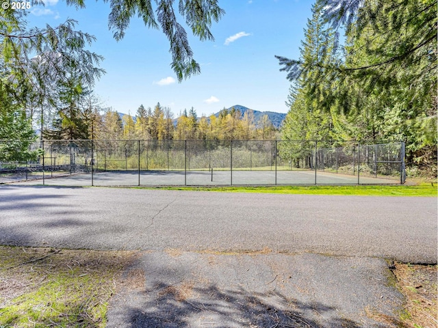 exterior space featuring a mountain view and fence