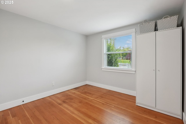 unfurnished bedroom with baseboards and light wood finished floors