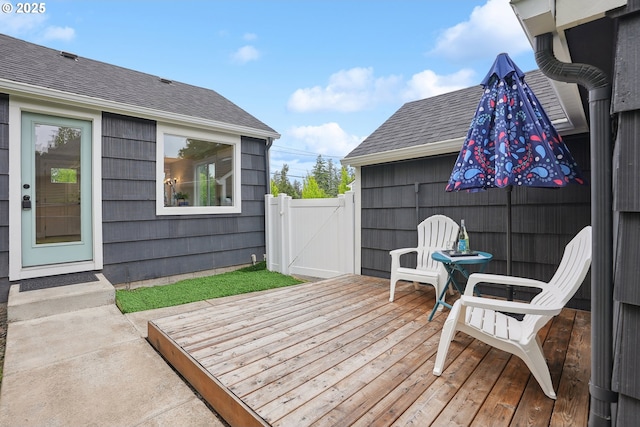 wooden deck with a gate and fence