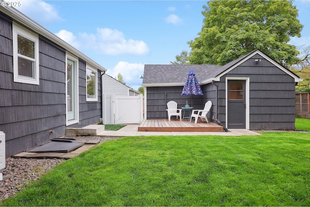 view of yard featuring a deck and a gate