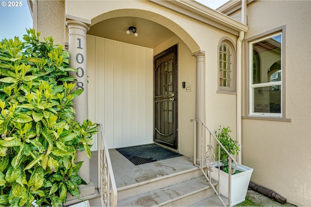 view of exterior entry featuring stucco siding