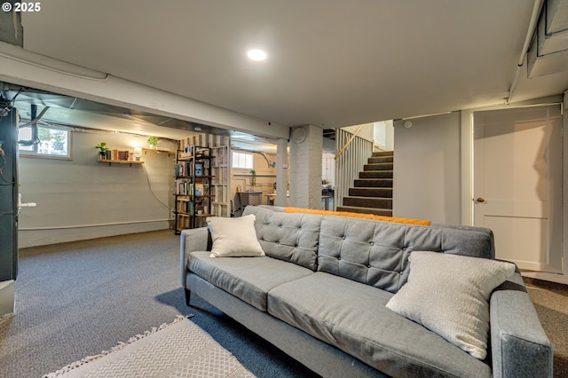 carpeted living area with stairs