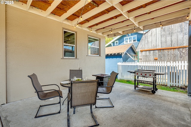 view of patio featuring fence and outdoor dining area