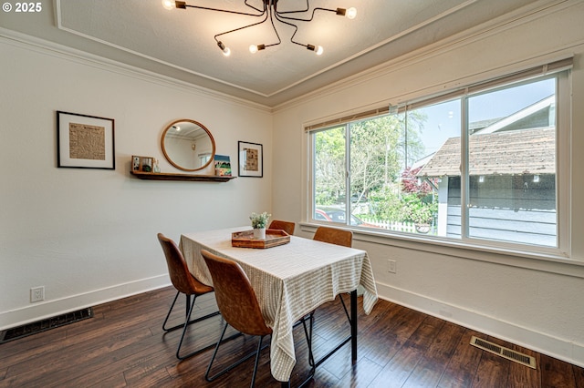 dining area with a notable chandelier, baseboards, visible vents, and ornamental molding