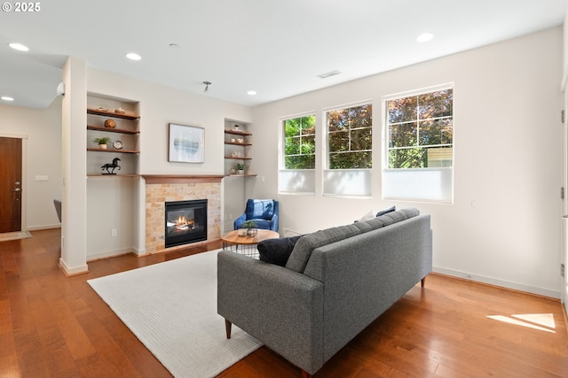 29229 SW Costa Cir E, Wilsonville, OR 97070 - living room featuring wood finished floors, a glass covered fireplace, baseboards, and recessed lighting