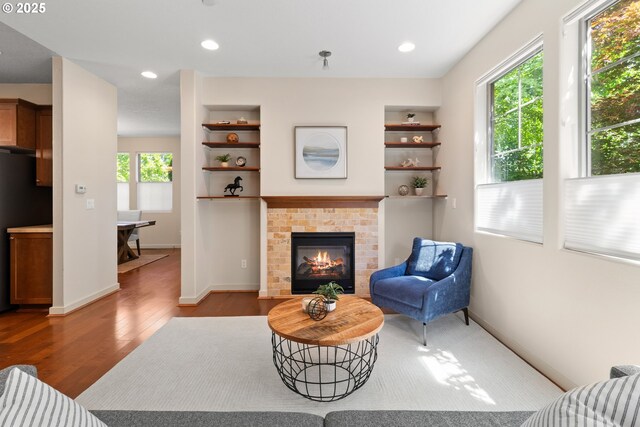 29229 SW Costa Cir E, Wilsonville, OR 97070 - living room featuring wood finished floors, a fireplace, baseboards, and recessed lighting