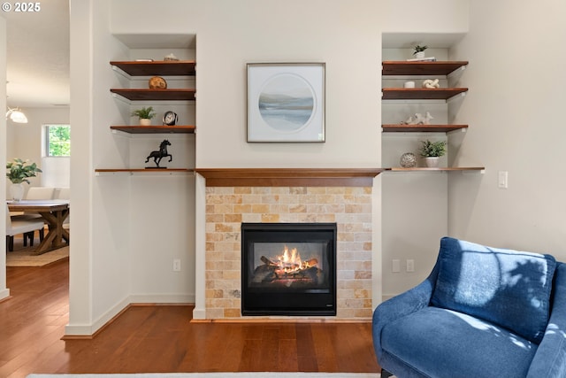 29229 SW Costa Cir E, Wilsonville, OR 97070 - living area featuring wood finished floors, a brick fireplace, and baseboards