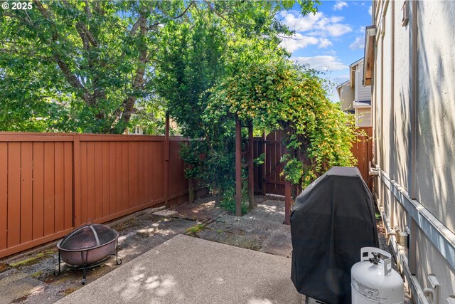29229 SW Costa Cir E, Wilsonville, OR 97070 - fenced backyard featuring a fire pit, a patio, and a grill