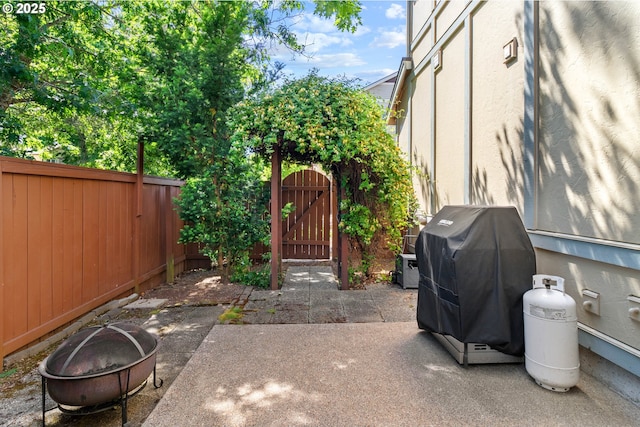 29229 SW Costa Cir E, Wilsonville, OR 97070 - fenced backyard with a fire pit, a gate, a patio area, and a grill