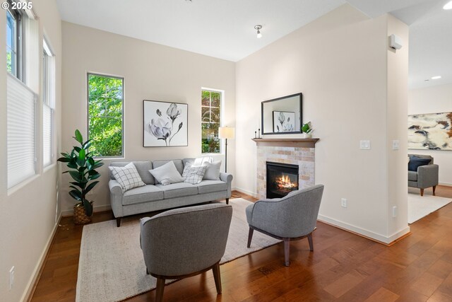 29229 SW Costa Cir E, Wilsonville, OR 97070 - living area with wood finished floors, a glass covered fireplace, and baseboards