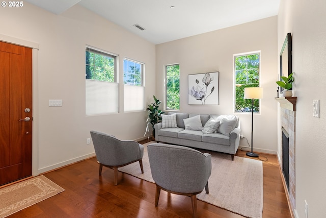 29229 SW Costa Cir E, Wilsonville, OR 97070 - living area featuring healthy amount of natural light, wood finished floors, a fireplace, and baseboards