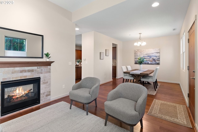 29229 SW Costa Cir E, Wilsonville, OR 97070 - living room with wood finished floors, baseboards, a chandelier, recessed lighting, and a brick fireplace