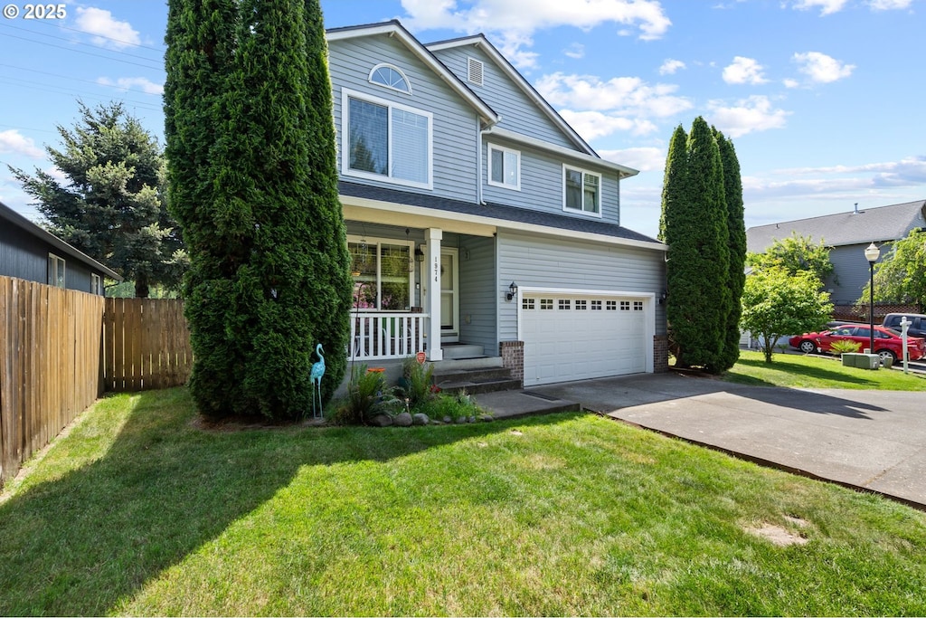 1974 Meadowood Loop, Woodland, WA 98674 - traditional-style house with a garage, concrete driveway, and covered porch