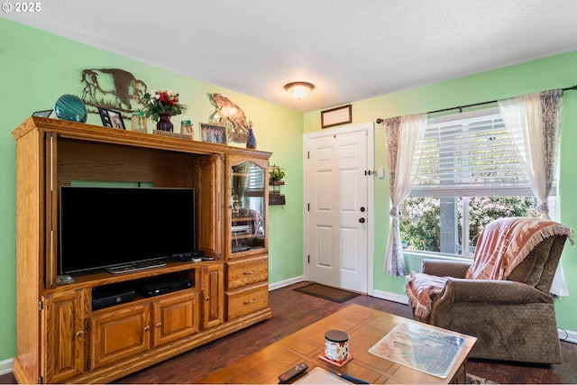 living room featuring dark wood-type flooring and baseboards