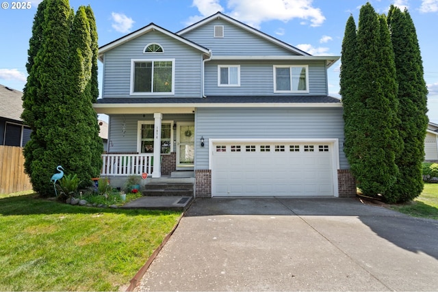 traditional-style home with brick siding, an attached garage, a porch, concrete driveway, and a front lawn
