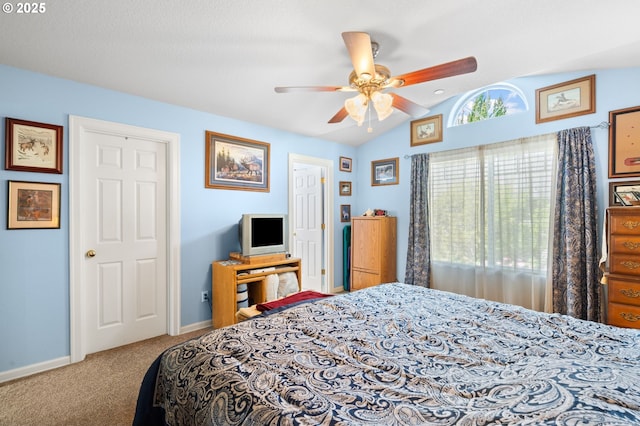 carpeted bedroom with vaulted ceiling, ceiling fan, and baseboards
