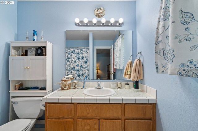 bathroom with toilet and vanity