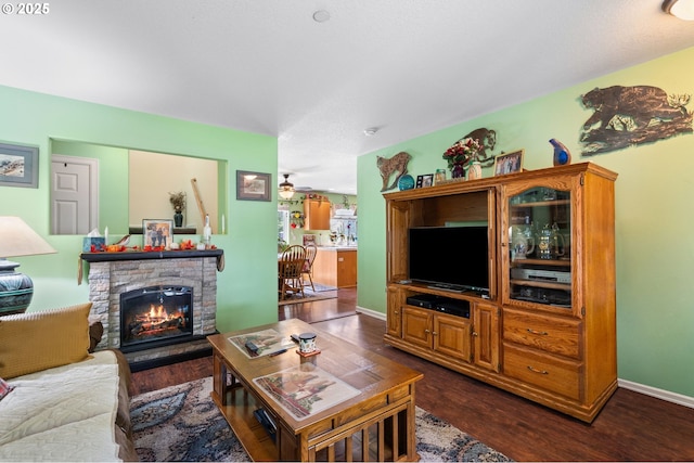 living area with dark wood finished floors and a fireplace