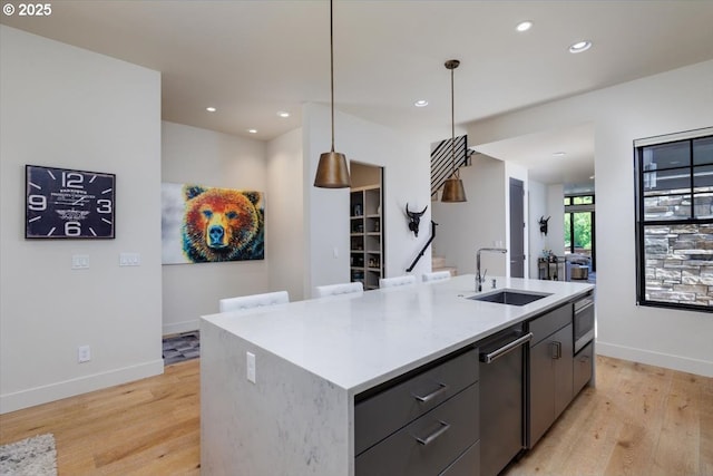 542 4th St, Lake Oswego, OR 97034 - kitchen with light wood-style floors, a center island with sink, recessed lighting, light countertops, and decorative light fixtures