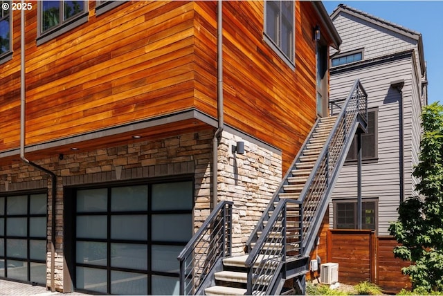 542 4th St, Lake Oswego, OR 97034 - view of side of property with stairway, an attached garage, and stone siding