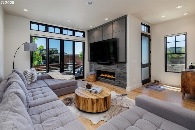542 4th St, Lake Oswego, OR 97034 - living room featuring light wood finished floors, a stone fireplace, and recessed lighting
