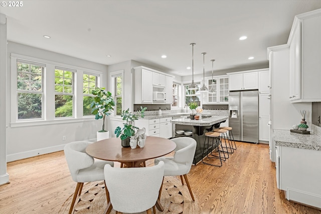 1206 NW Mayfield Rd, Portland, OR 97229 - dining area featuring light wood finished floors, recessed lighting, and baseboards