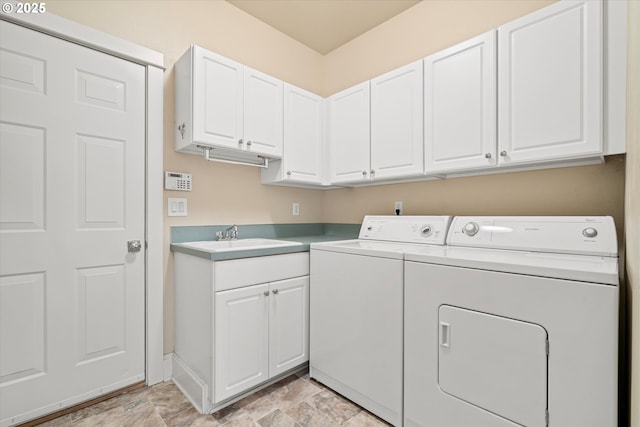 1206 NW Mayfield Rd, Portland, OR 97229 - laundry room with washer and clothes dryer, cabinet space, stone finish flooring, and baseboards