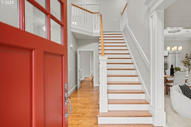 1206 NW Mayfield Rd, Portland, OR 97229 - entrance foyer with stairway, a towering ceiling, wood finished floors, a chandelier, and crown molding