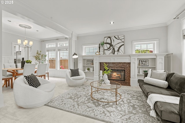 1206 NW Mayfield Rd, Portland, OR 97229 - living room featuring a glass covered fireplace, crown molding, and a chandelier