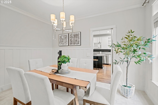1206 NW Mayfield Rd, Portland, OR 97229 - dining space with a chandelier, crown molding, a decorative wall, and a wainscoted wall
