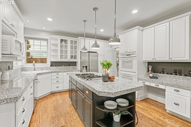 1206 NW Mayfield Rd, Portland, OR 97229 - kitchen with open shelves, stainless steel appliances, a sink, white cabinets, and recessed lighting