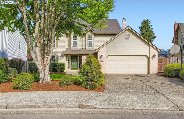 5839 NW Necanicum Way, Portland, OR 97229 - view of front of house with an attached garage, concrete driveway, and brick siding