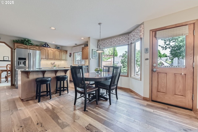 5839 NW Necanicum Way, Portland, OR 97229 - dining room with healthy amount of natural light, light wood-style flooring, and recessed lighting