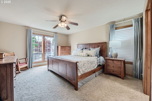 5839 NW Necanicum Way, Portland, OR 97229 - bedroom with light carpet and a ceiling fan