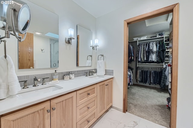 5839 NW Necanicum Way, Portland, OR 97229 - bathroom featuring double vanity, marble look tiles, a spacious closet, an enclosed shower, and tasteful backsplash