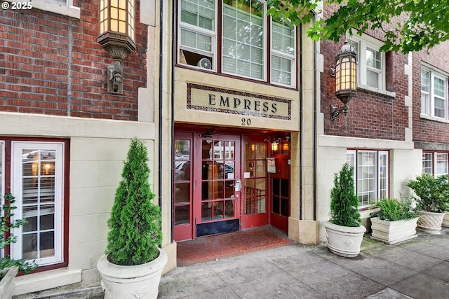 doorway to property with brick siding