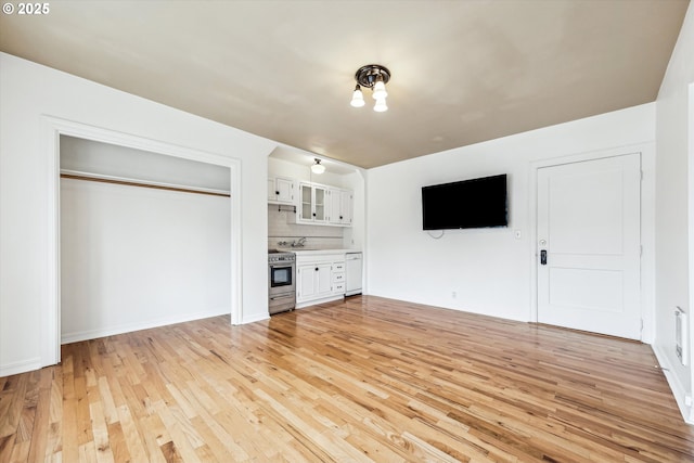 unfurnished living room with light wood finished floors