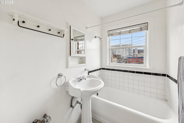 full bath featuring a washtub and plenty of natural light