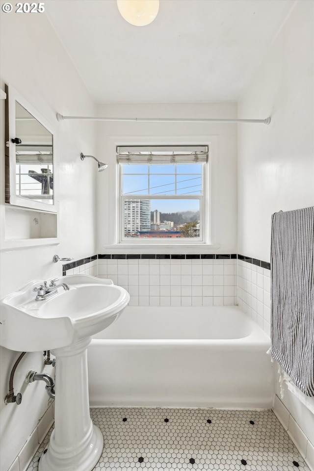 full bathroom with tile patterned flooring and a bathing tub