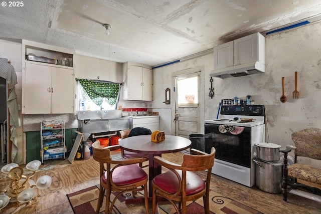 212 N Main St, Merrill, OR 97633 - kitchen with electric range, wood finished floors, and under cabinet range hood