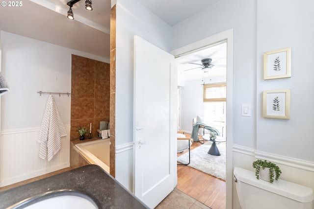 125 NE 80th Ave, Portland, OR 97213 - bathroom with a wainscoted wall, ceiling fan, and a bathtub