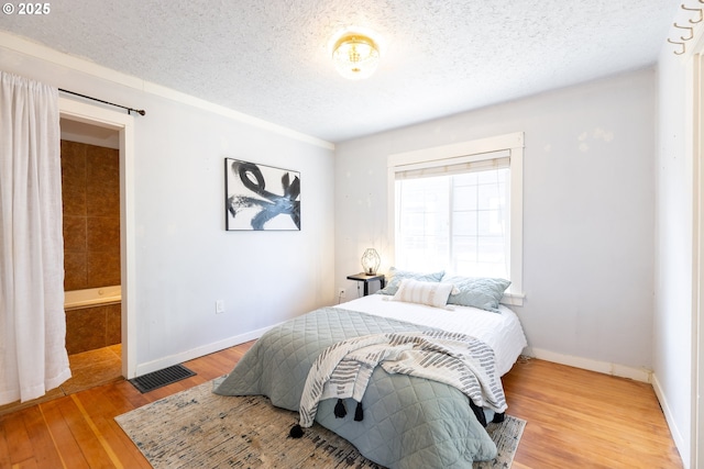 125 NE 80th Ave, Portland, OR 97213 - bedroom featuring a textured ceiling and light wood-style flooring