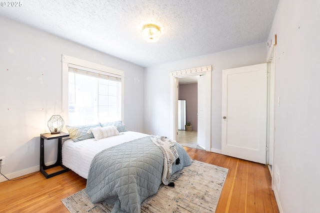 125 NE 80th Ave, Portland, OR 97213 - bedroom featuring a textured ceiling and light wood-style floors