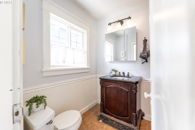 125 NE 80th Ave, Portland, OR 97213 - half bath featuring a wainscoted wall, vanity, and tile patterned flooring